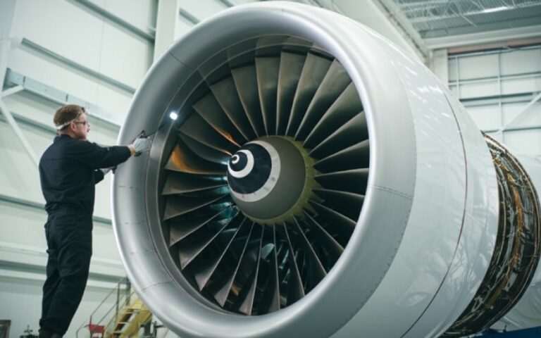 Engineer inspecting a jet engine