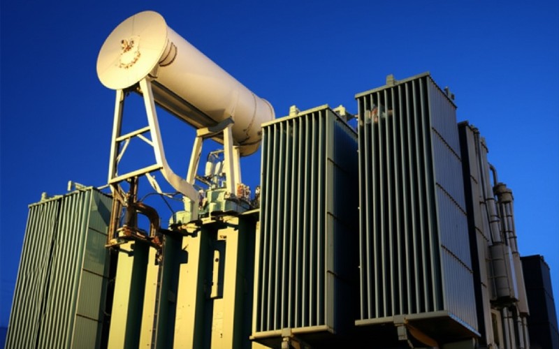 Large industrial power transformer at dusk
