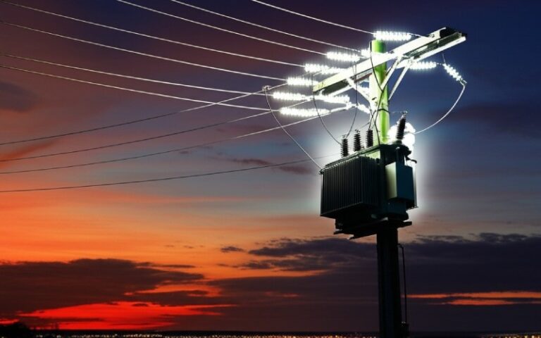 Pole-mounted transformer at sunset