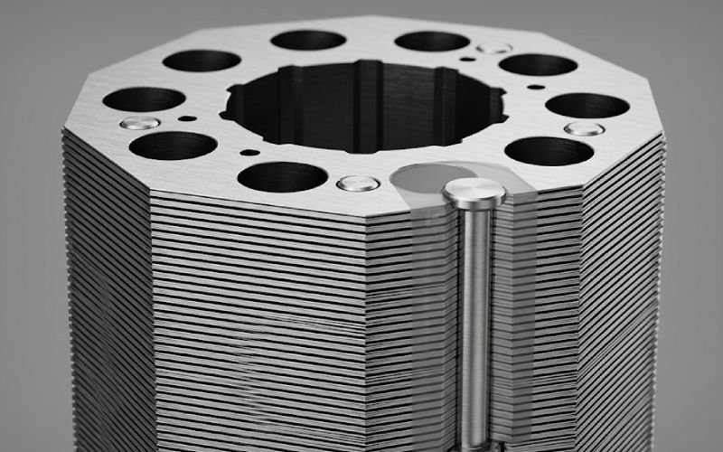 laminated steel stack showing rivet hole layout and layered edges